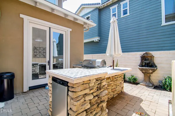 a spacious bathroom with a granite countertop sink and a toilet