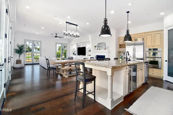 a open kitchen with white cabinets and stainless steel appliances