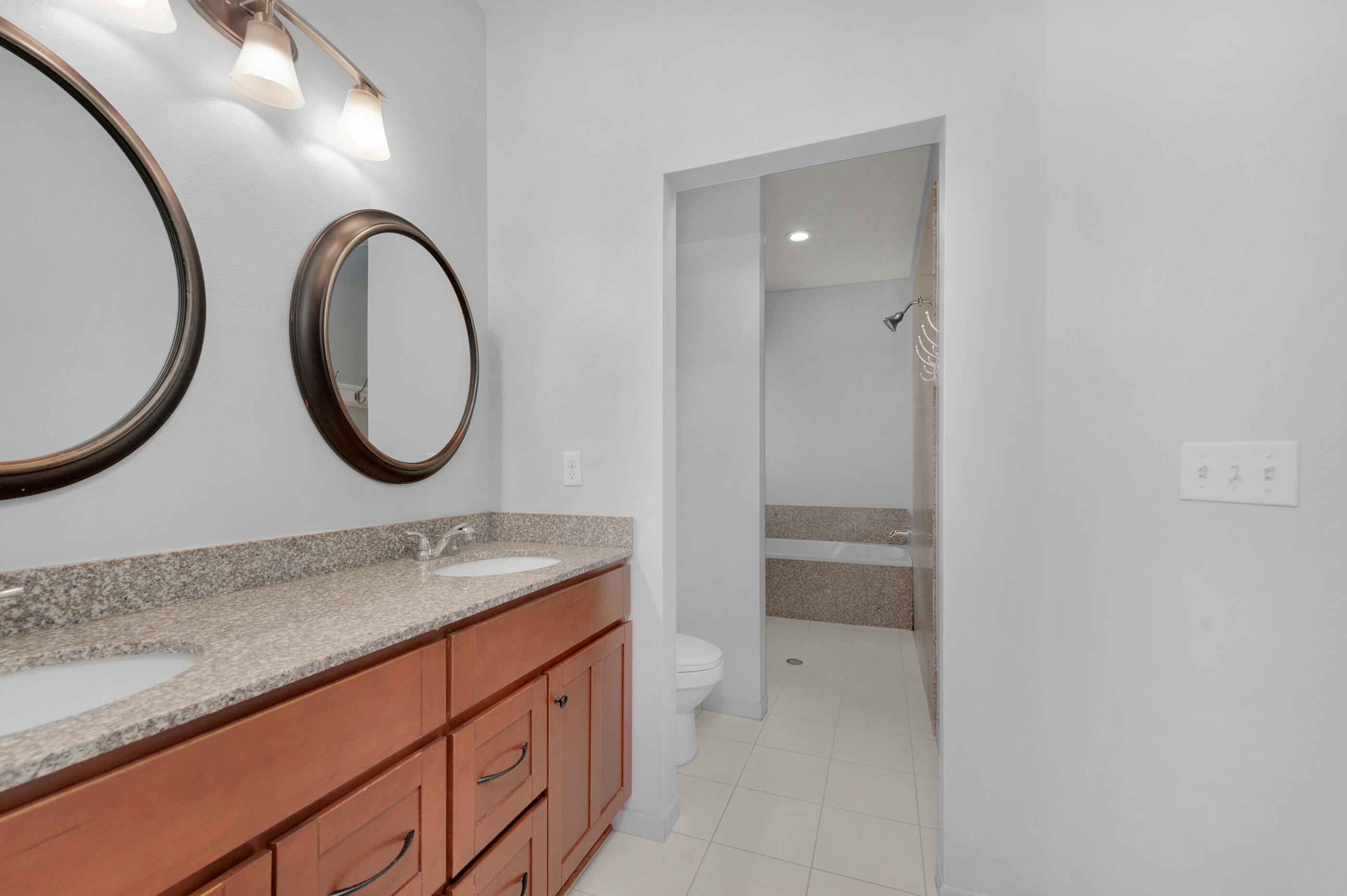 4586 Hermosa Road Crestview, FL 32539 - Photo 18 of 26 a bathroom with a granite countertop double vanity sink and a mirror