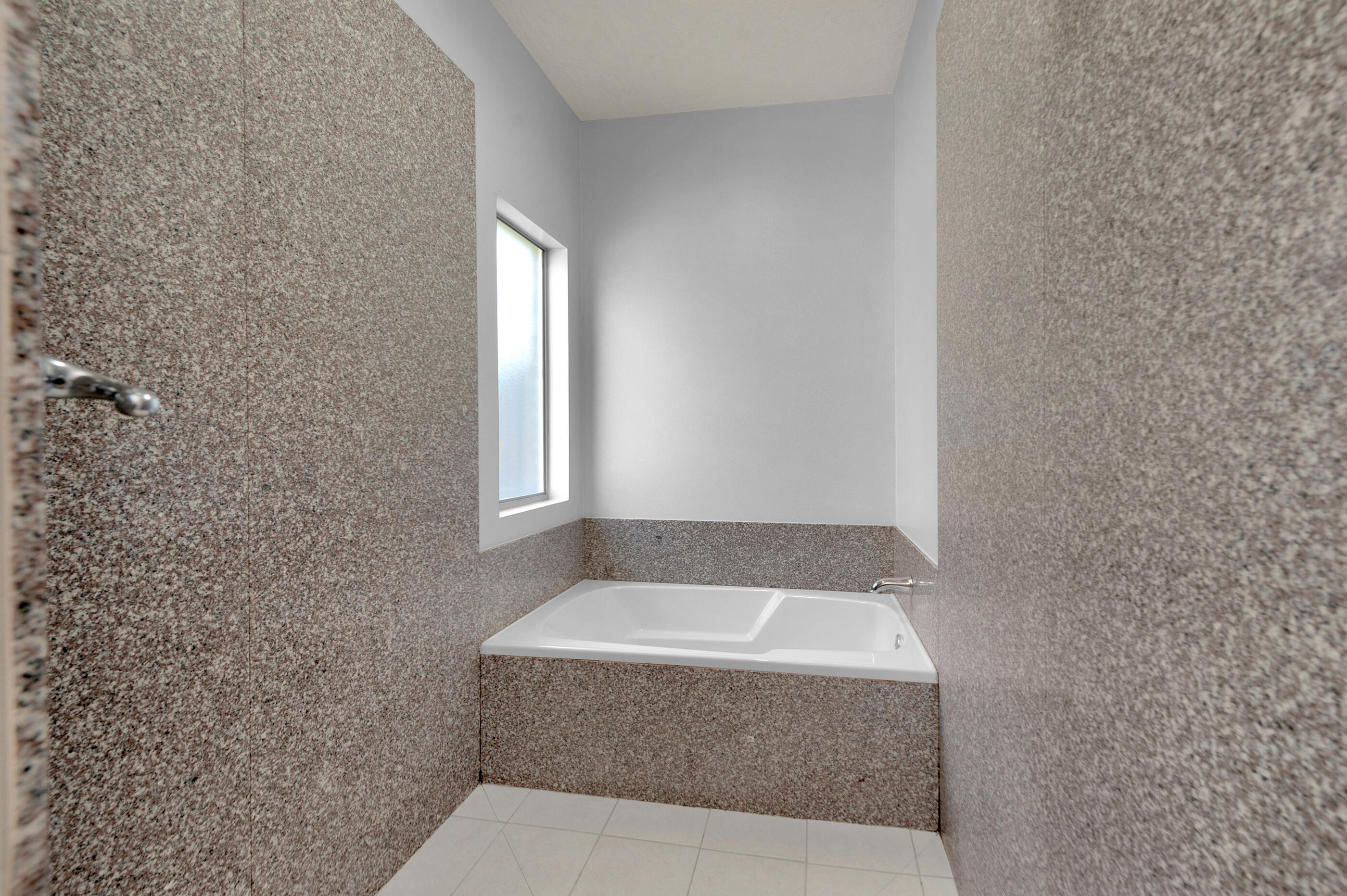 4586 Hermosa Road Crestview, FL 32539 - Photo 19 of 26 a bathroom with a bathtub and window