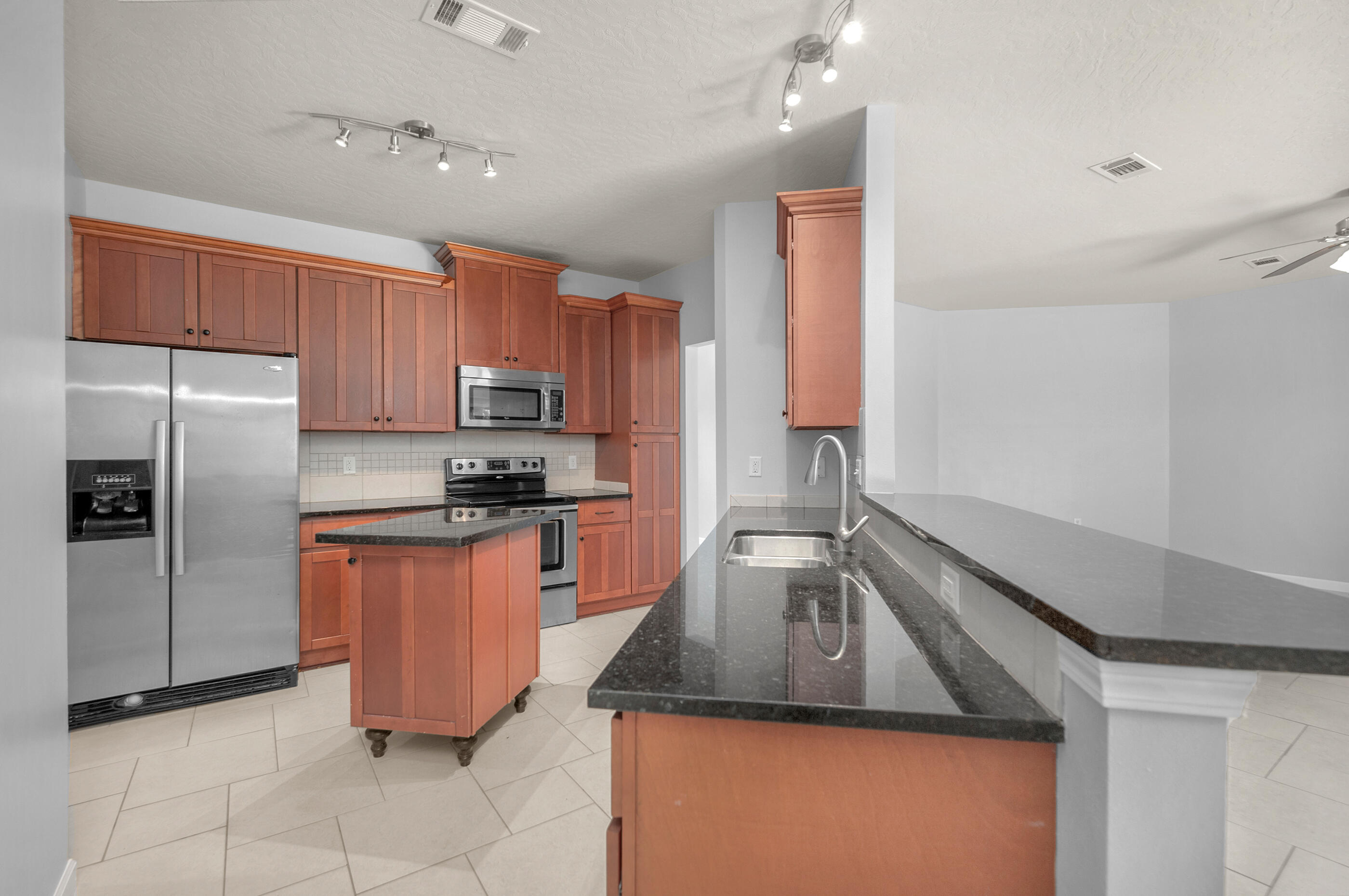 4586 Hermosa Road Crestview, FL 32539 - Photo 9 of 26 a kitchen with granite countertop a sink stainless steel appliances and cabinets