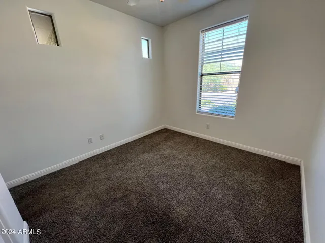 an empty room with a empty space and windows