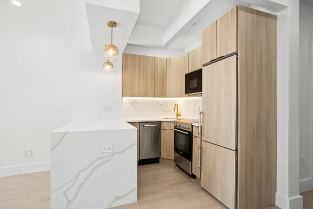 a kitchen with a refrigerator and a sink