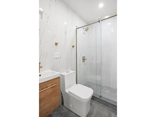 a bathroom with a toilet a sink and shower