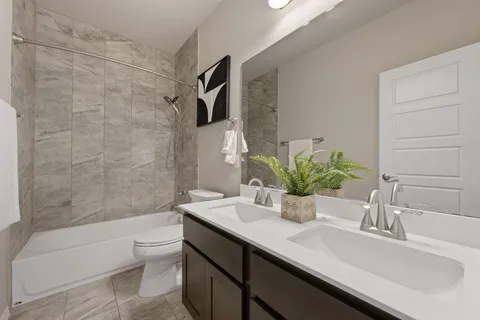 a bathroom with a sink a toilet and tub