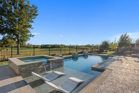 a view of a swimming pool with seating area and lake view