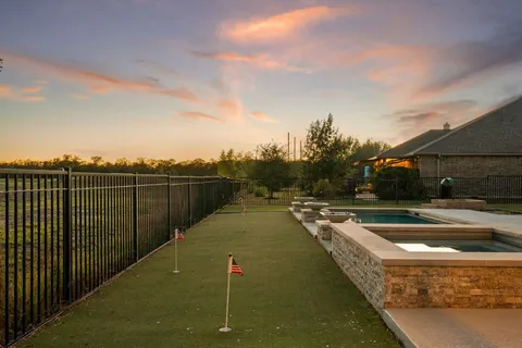 a view of a swimming pool with a yard
