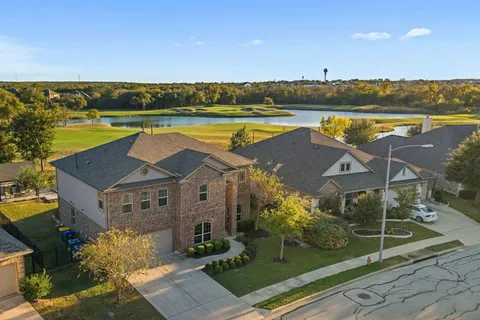 an aerial view of a house with a swimming pool and outdoor seating