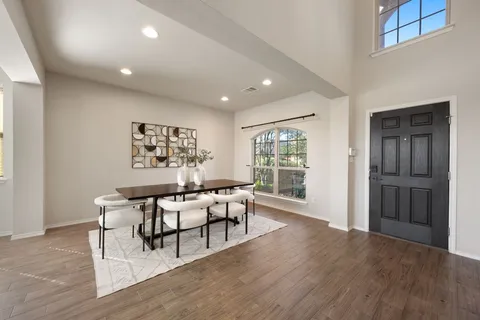 a view of a work space with wooden floor and furniture