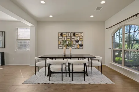 a dining room with furniture and window