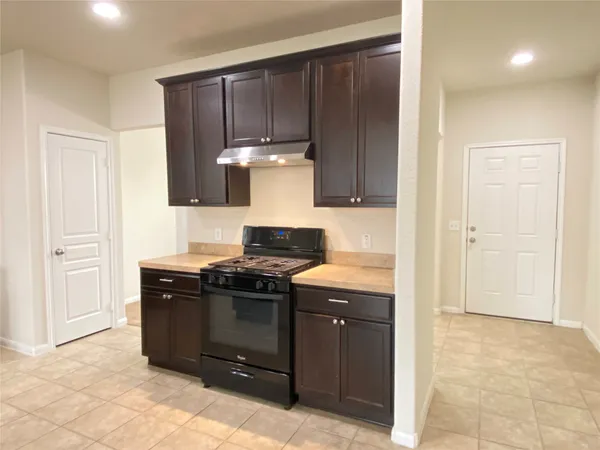a kitchen with a stove and a cabinets