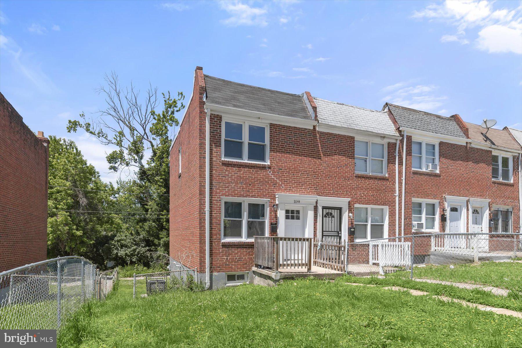 1044 Ellicott Driveway Baltimore, MD 21216 - Photo 2 of 26 a view of a house with a yard