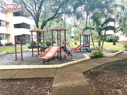 a view of a park with swings and slides