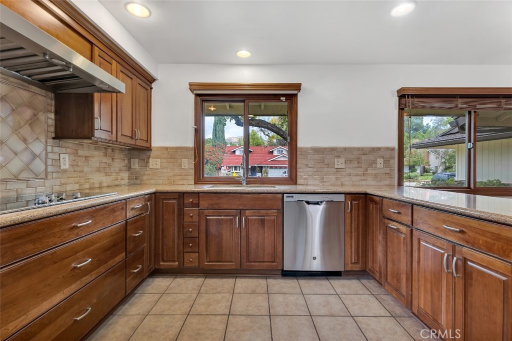 19034 Killoch Way Porter Ranch, CA 91326 - Photo 11 of 42 a kitchen with stainless steel appliances granite countertop a sink and cabinets