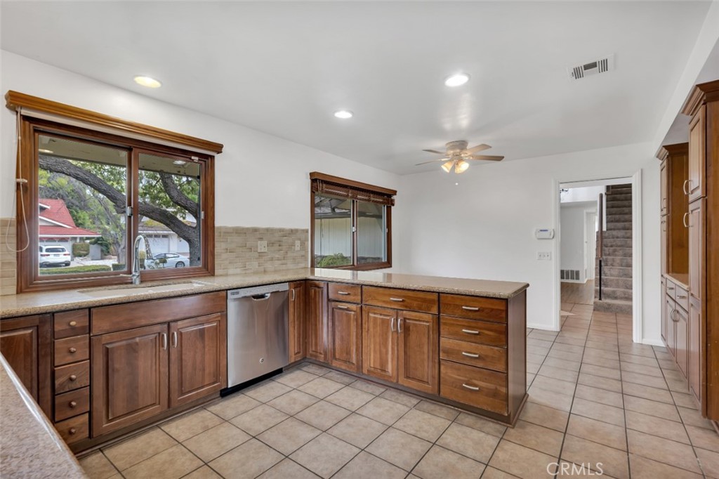 19034 Killoch Way Porter Ranch, CA 91326 - Photo 13 of 42 a large kitchen with stainless steel appliances granite countertop a sink and cabinets