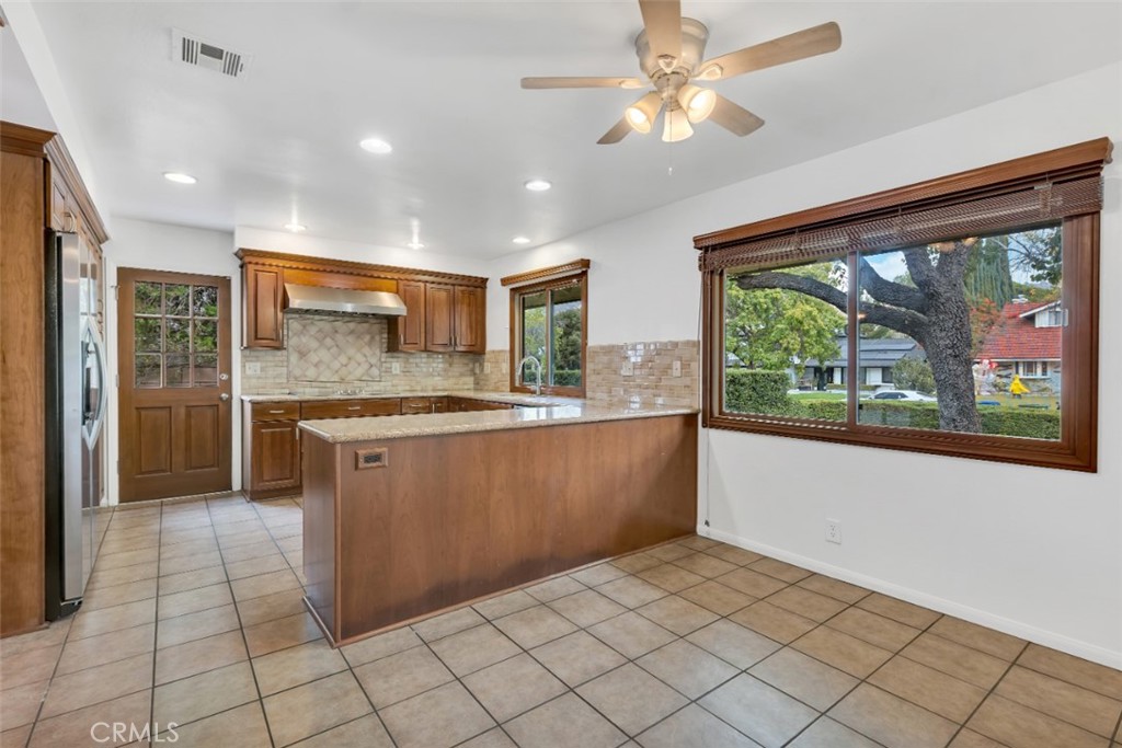 19034 Killoch Way Porter Ranch, CA 91326 - Photo 14 of 42 a large kitchen with a large window cabinets and stainless steel appliances
