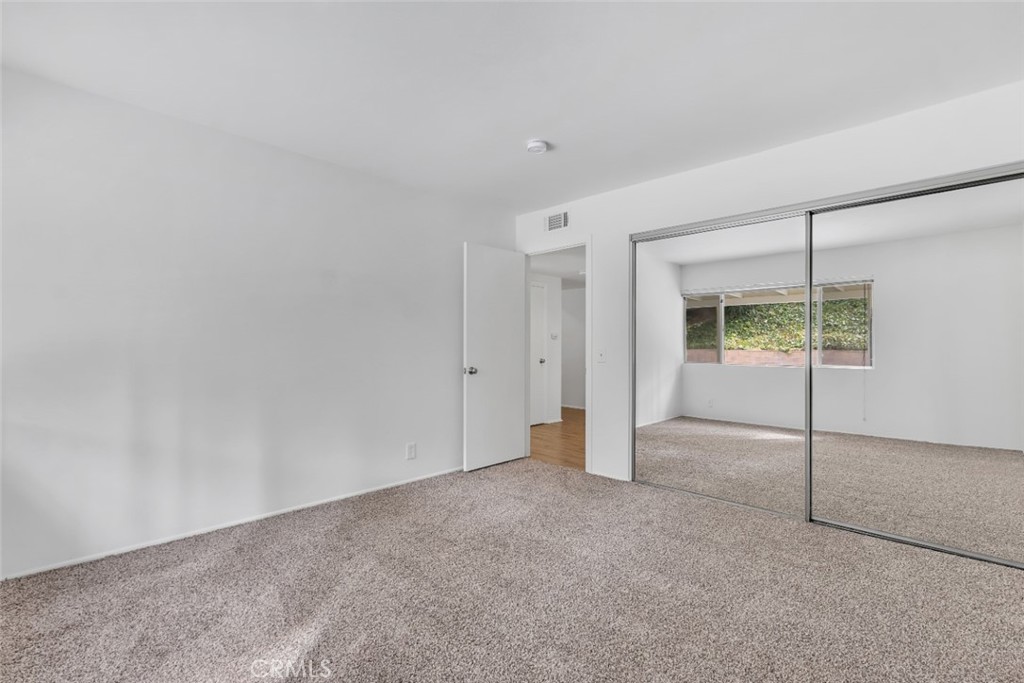19034 Killoch Way Porter Ranch, CA 91326 - Photo 16 of 42 an empty room with sliding glass door and shower