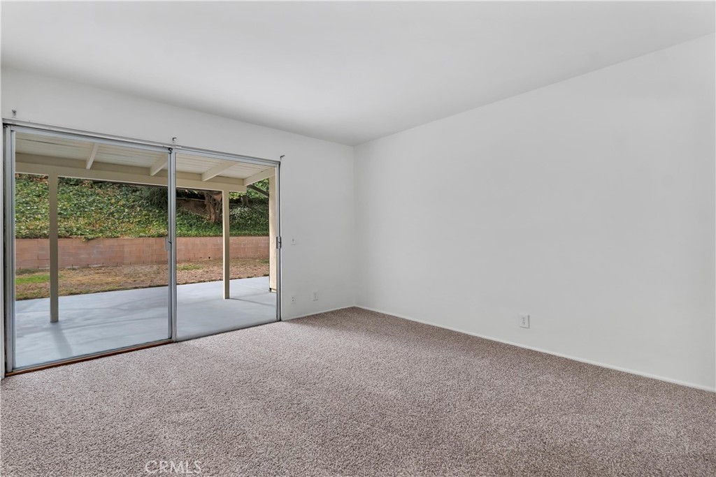 19034 Killoch Way Porter Ranch, CA 91326 - Photo 18 of 42 a view of an empty room with wooden floor and sliding door