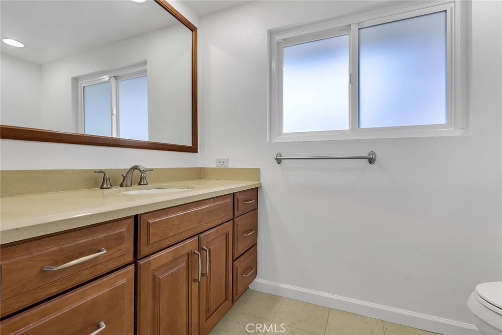 19034 Killoch Way Porter Ranch, CA 91326 - Photo 23 of 42 a bathroom with a sink a toilet and mirror