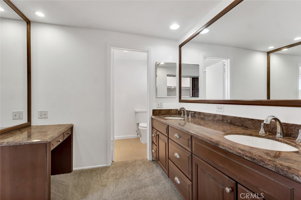 19034 Killoch Way Porter Ranch, CA 91326 - Photo 30 of 42 a bathroom with a granite countertop sink and a mirror