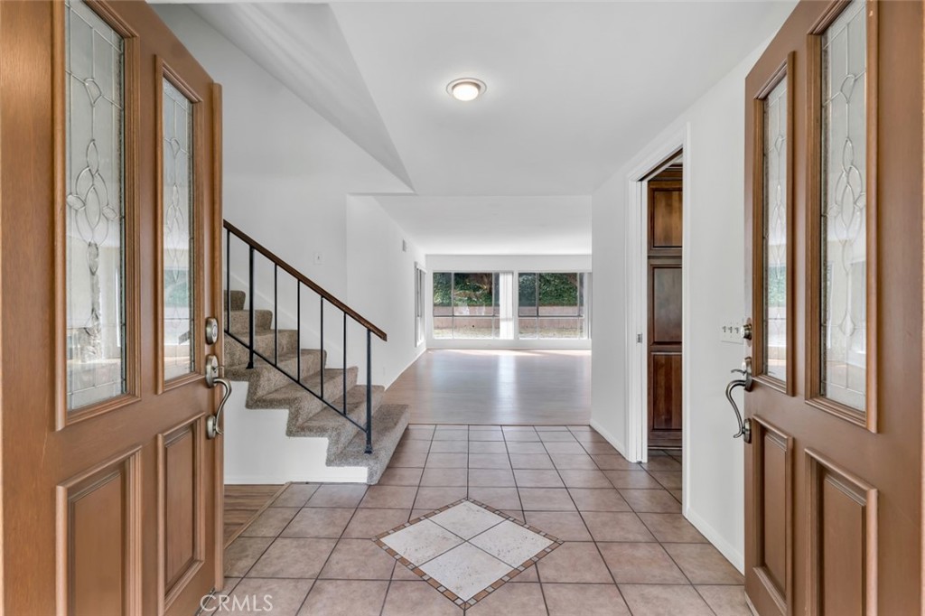 19034 Killoch Way Porter Ranch, CA 91326 - Photo 3 of 42 a view of a hallway with wooden floor and staircase
