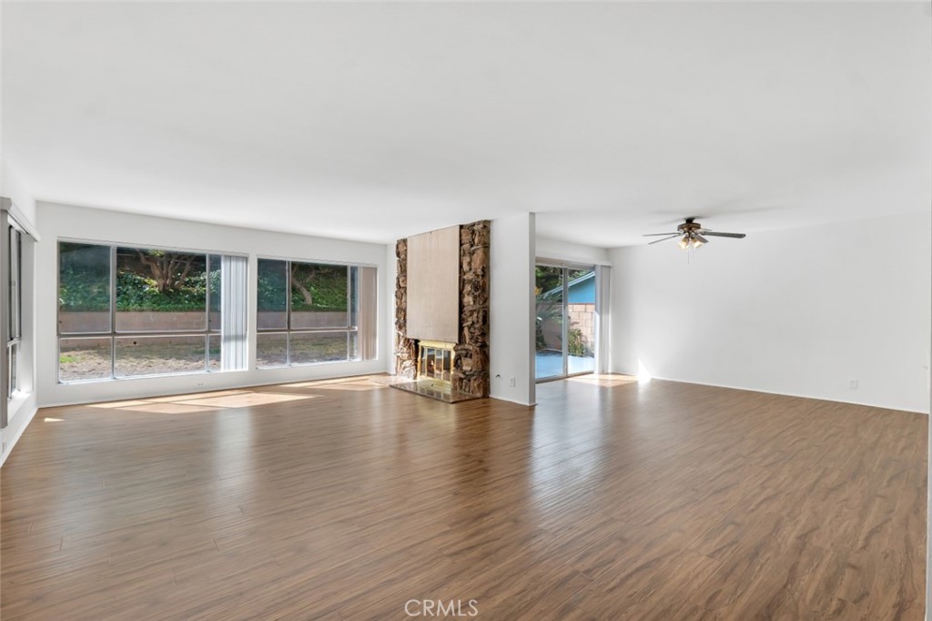 19034 Killoch Way Porter Ranch, CA 91326 - Photo 4 of 42 an empty room with wooden floor and windows
