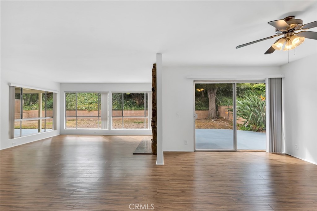 19034 Killoch Way Porter Ranch, CA 91326 - Photo 7 of 42 a view of an empty room with wooden floor and a window