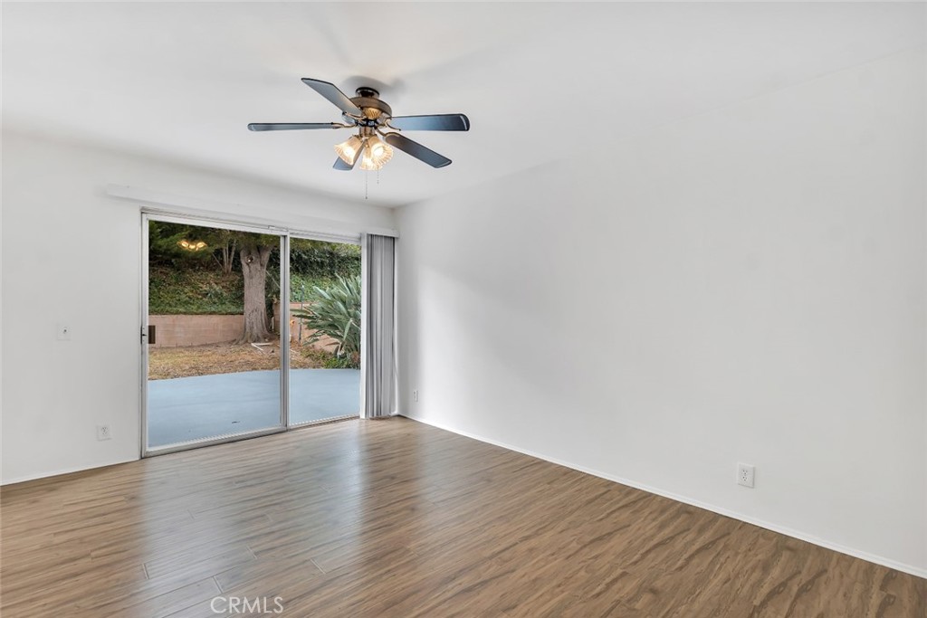 19034 Killoch Way Porter Ranch, CA 91326 - Photo 9 of 42 a view of an empty room with wooden floor and a window