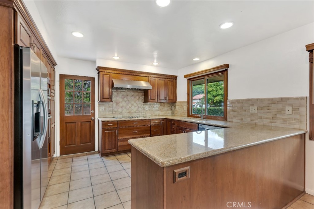 19034 Killoch Way Porter Ranch, CA 91326 - Photo 10 of 42 a kitchen with a sink a refrigerator and cabinets