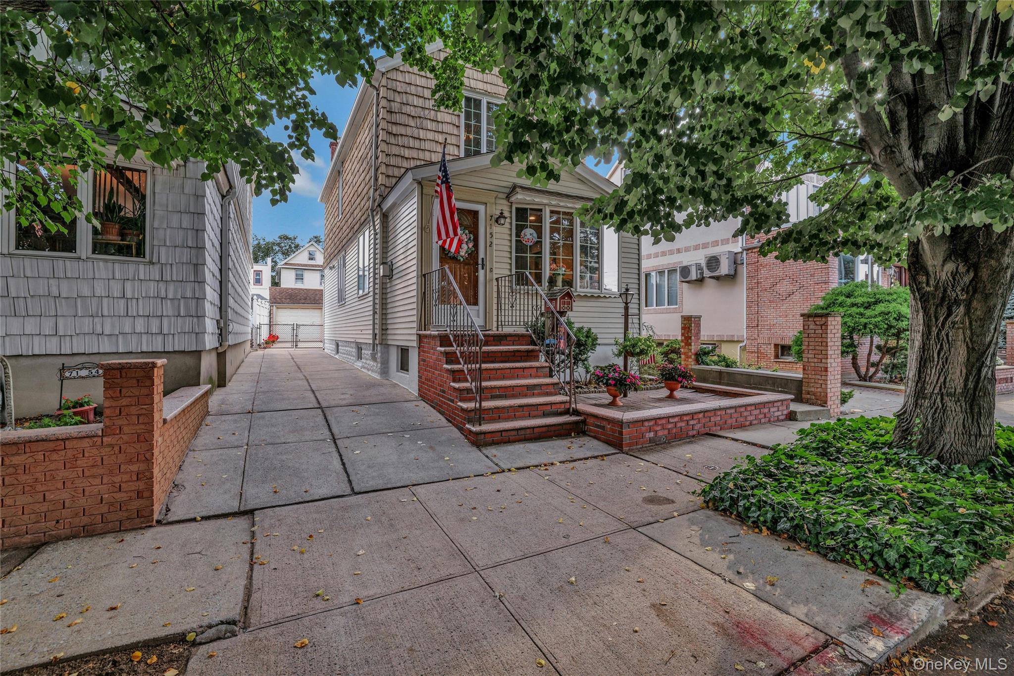 71-52 58th Road Queens, NY 11378 - Photo 1 of 1 a view of a patio with table and chairs and potted plants