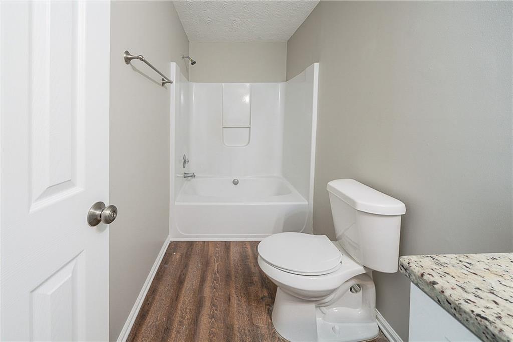 2183 Ramblewood Circle Decatur, GA 30035 - Photo 12 of 37 a bathroom with a granite countertop toilet a sink and a shower