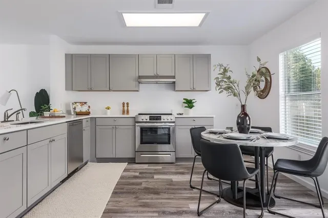 a kitchen with a sink cabinets and window