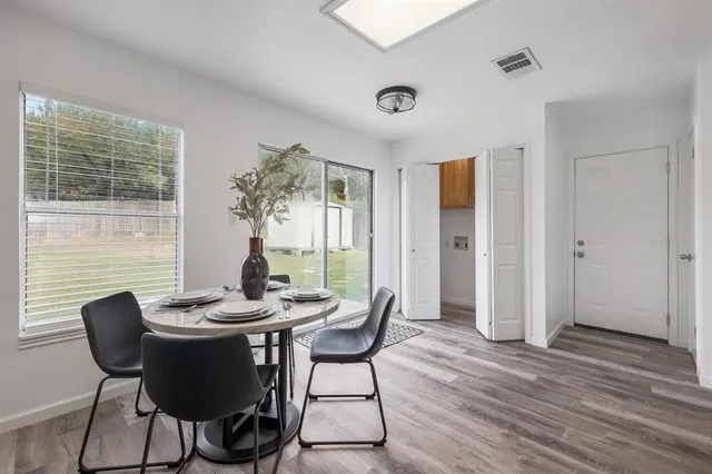 a view of a dining room with furniture window and wooden floor