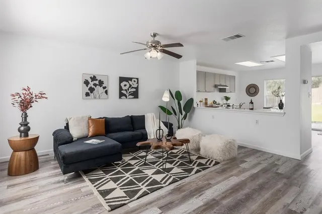 a living room with furniture and wooden floor