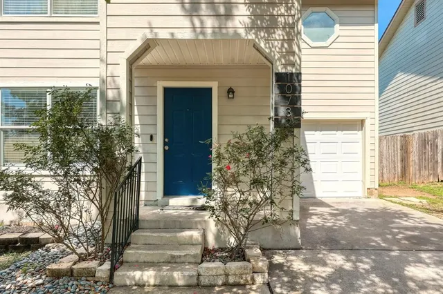 a front view of a house with trees