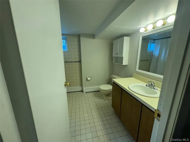 a bathroom with a sink a toilet and mirror