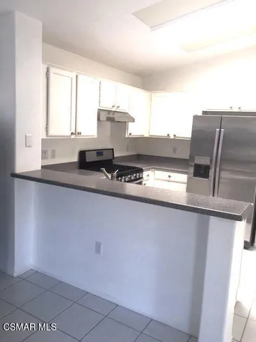 a kitchen with stainless steel appliances a sink and a window