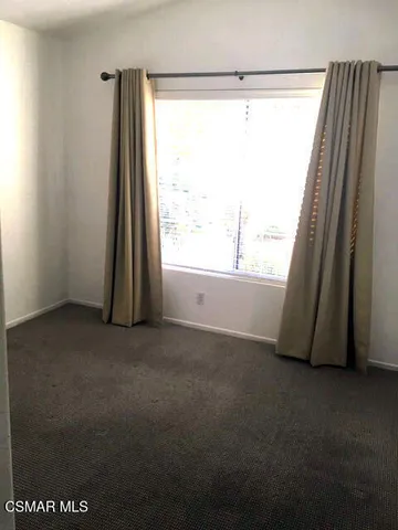 a view of a room that has a large window