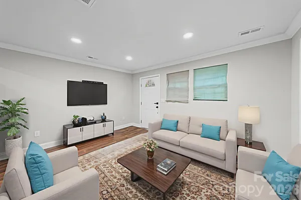 a living room with furniture and a flat screen tv