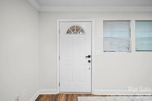 a view of a room with a empty space and window