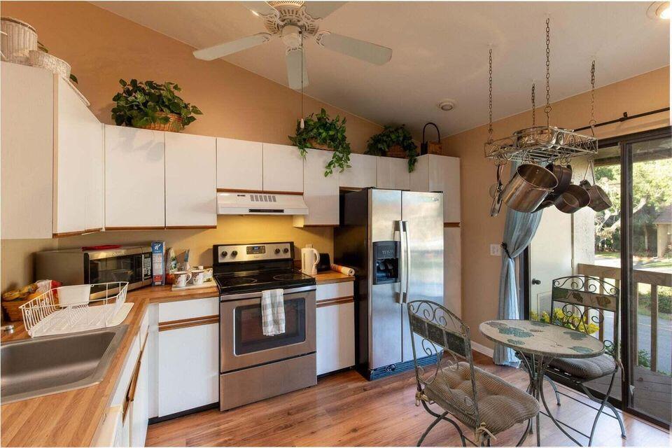 13045 Albright Court, Unit 12 Wellington, FL 33414 - Photo 3 of 11 a kitchen with a sink a counter space appliances and cabinets