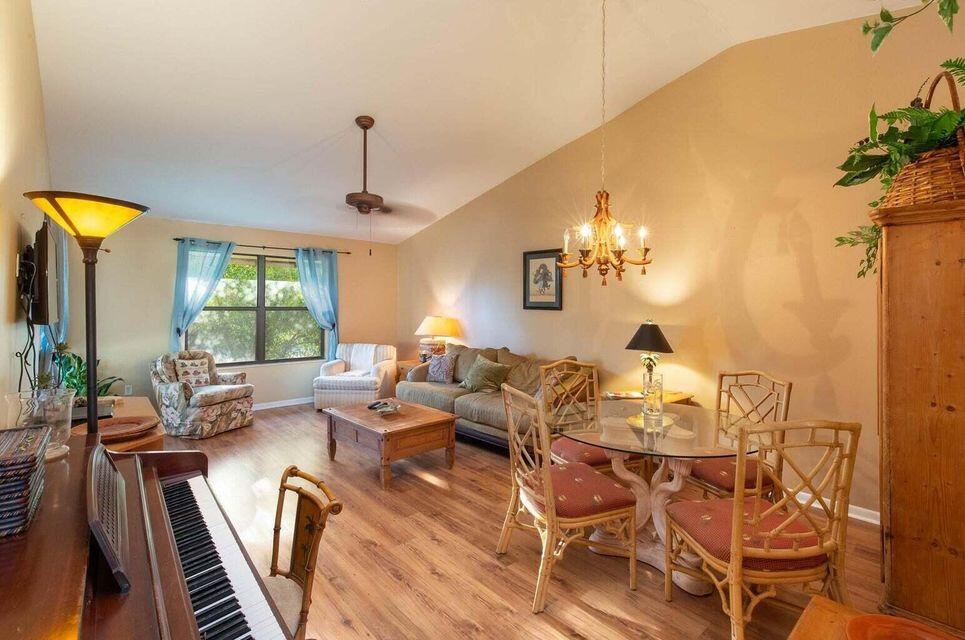 13045 Albright Court, Unit 12 Wellington, FL 33414 - Photo 4 of 11 a living room with furniture and a chandelier