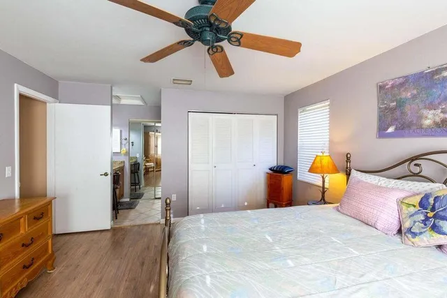 a bedroom with furniture and wooden floor