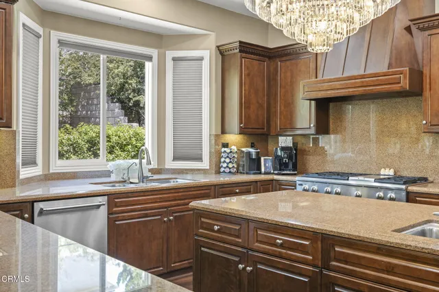 a living room with furniture a large window and a fireplace
