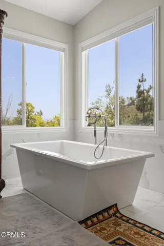 a spacious bedroom with a bed and a window