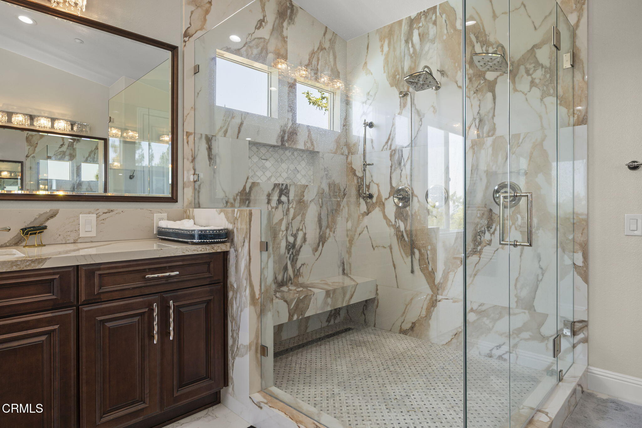 12390 Nelson Road Moorpark, CA 93021 - Photo 35 of 66 a spacious bathroom with a granite countertop sink a mirror and shower