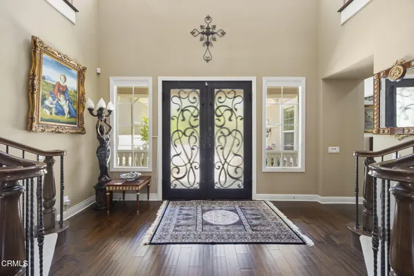 a view of entryway and hall with wooden floor