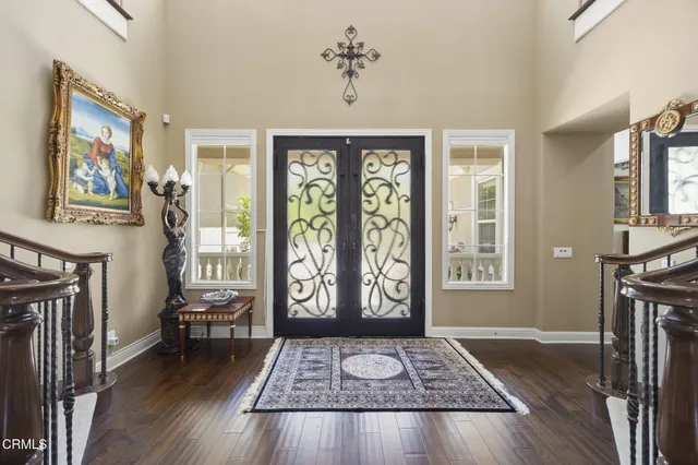 a view of entryway and hall with wooden floor