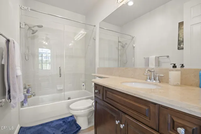 a entryway view of a building with potted plants and seating space