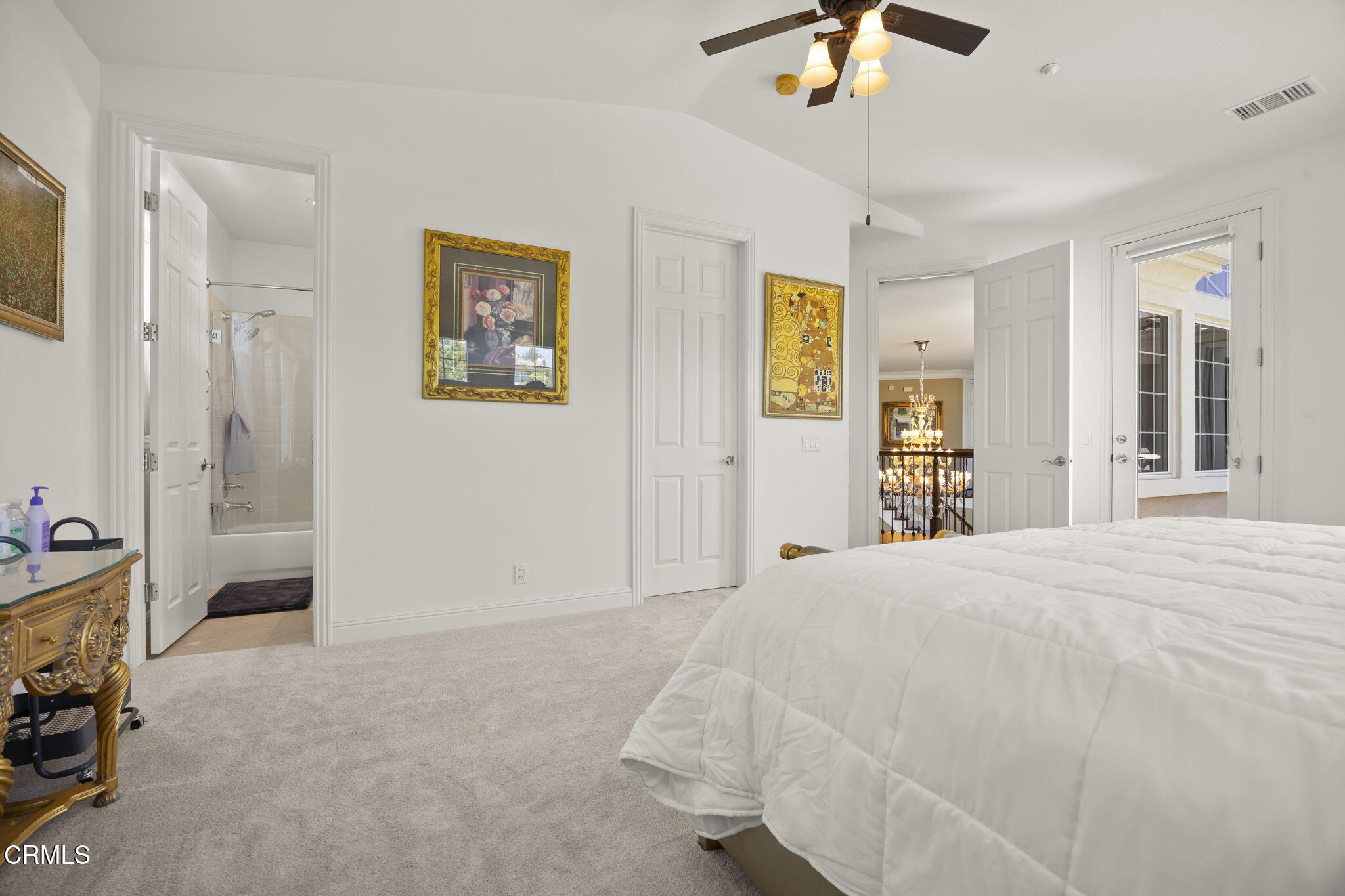 12390 Nelson Road Moorpark, CA 93021 - Photo 45 of 66 a bedroom with a bed and a chandelier